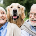 Smiling Old Couple with a Dog in Between
